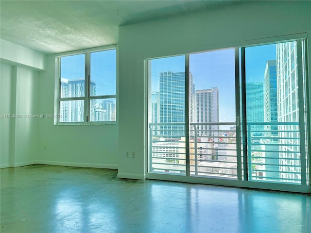133 NE 2nd Ave Unit 1905, Miami, FL 33132 - empty room featuring a city view, a textured ceiling, and concrete floors