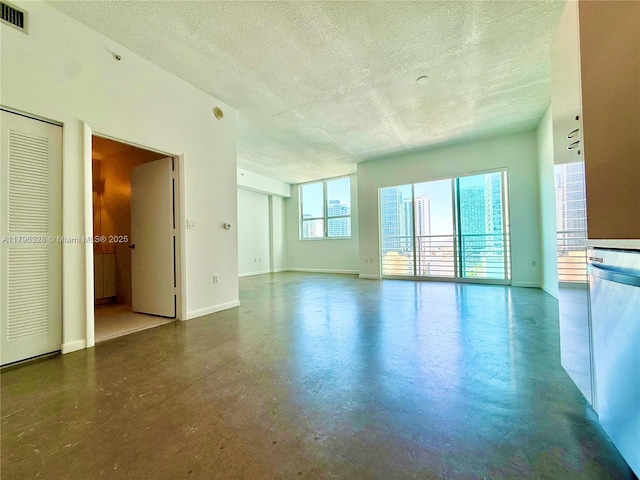 133 NE 2nd Ave Unit 1905, Miami, FL 33132 - unfurnished living room featuring a textured ceiling and concrete floors