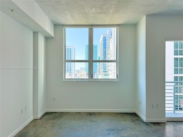 133 NE 2nd Ave Unit 1905, Miami, FL 33132 - spare room with a textured ceiling, a city view, and concrete floors