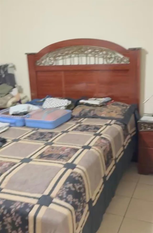 6055 W 19th Ave Unit 417, Hialeah, FL 33012 - bedroom featuring light tile patterned floors