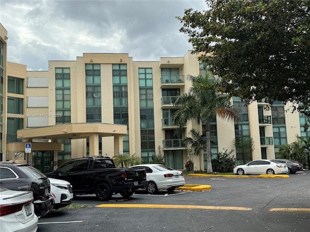 view of building exterior with uncovered parking