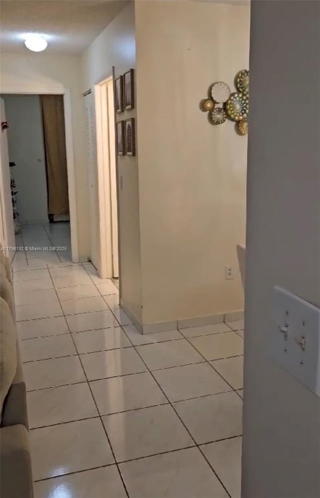 hallway with light tile patterned flooring