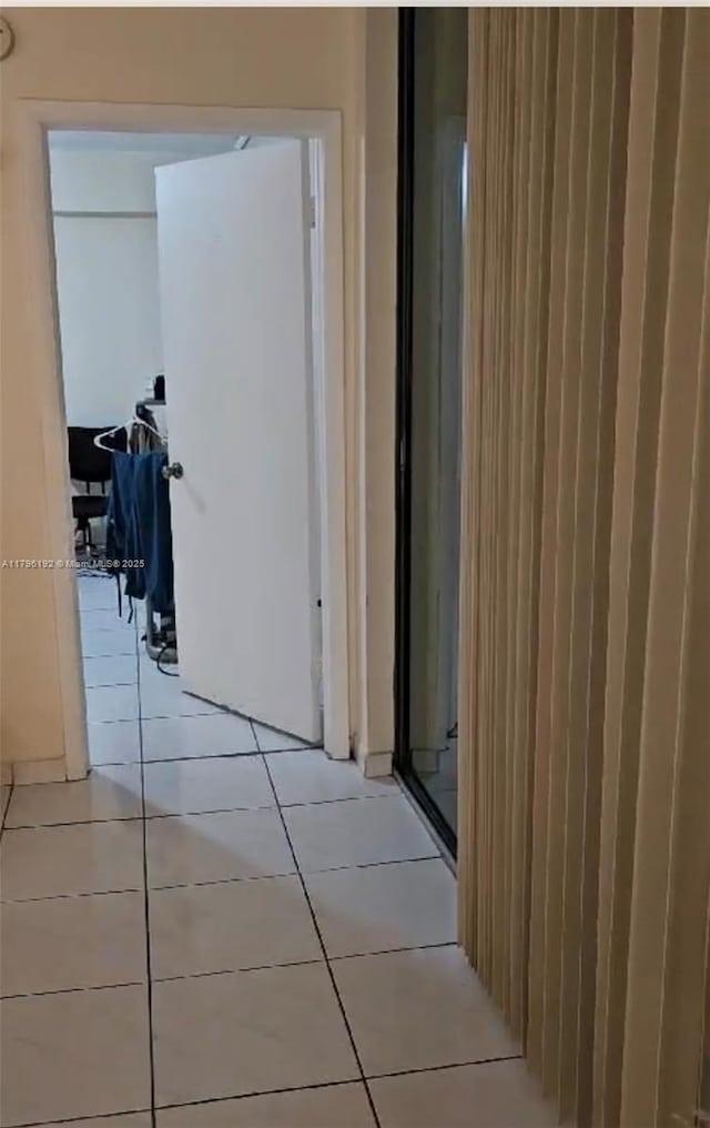 corridor featuring light tile patterned floors