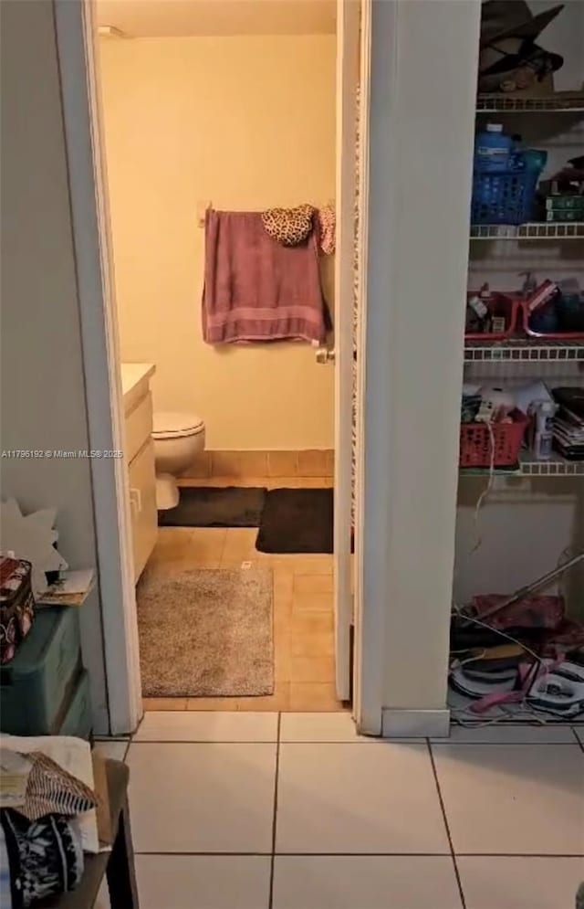 bathroom with vanity, tile patterned floors, and toilet