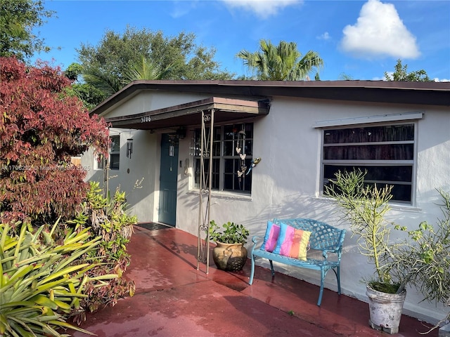 5706 Simms St, Hollywood, FL 33021 - entrance to property with stucco siding and a patio area