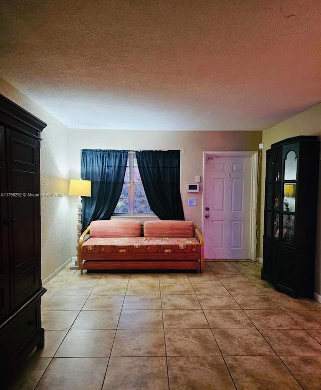 5706 Simms St, Hollywood, FL 33021 - tiled living area with a textured ceiling and baseboards