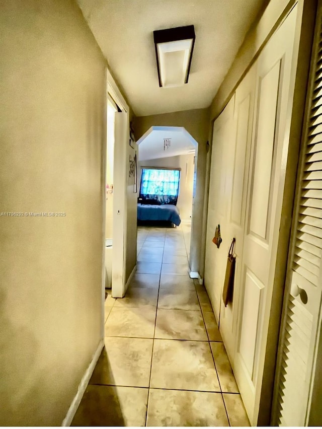 5706 Simms St, Hollywood, FL 33021 - hallway with light tile patterned flooring, arched walkways, and baseboards