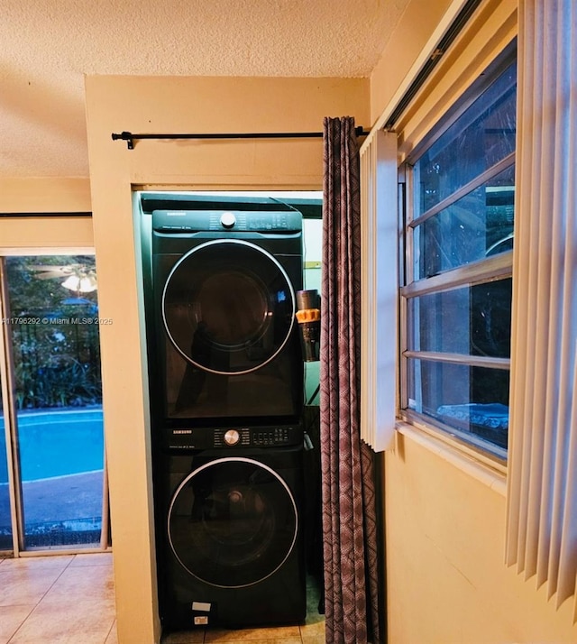 5706 Simms St, Hollywood, FL 33021 - washroom with estacked washer and dryer, a textured ceiling, and tile patterned floors