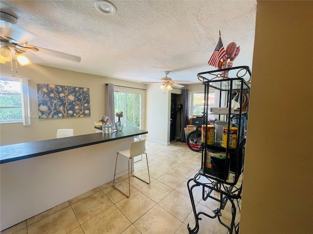 5706 Simms St, Hollywood, FL 33021 - dining area with a ceiling fan, healthy amount of natural light, a textured ceiling, and light tile patterned floors