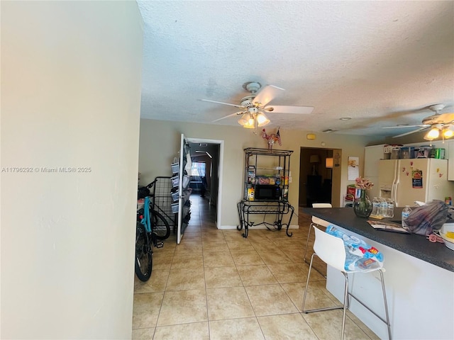 5706 Simms St, Hollywood, FL 33021 - hall with light tile patterned floors and a textured ceiling