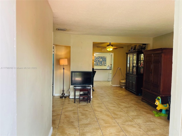 5706 Simms St, Hollywood, FL 33021 - living area featuring a textured ceiling, ceiling fan, light tile patterned floors, and baseboards