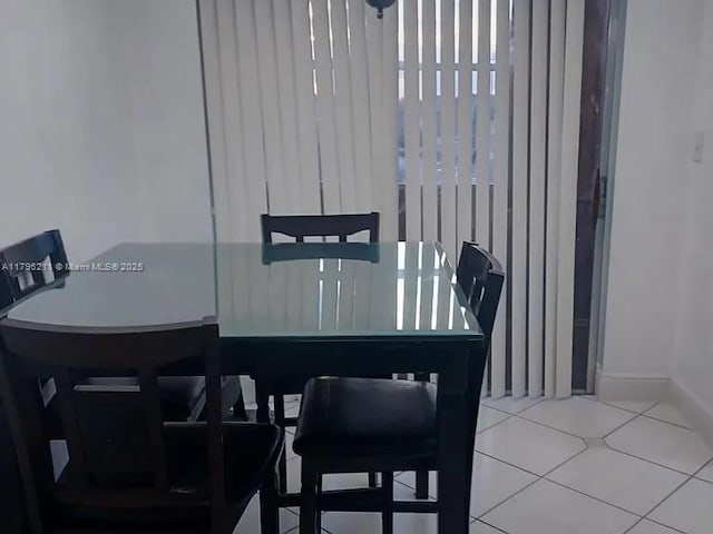 6620 W 2nd Ct Unit 407, Hialeah, FL 33012 - dining area featuring tile patterned floors and baseboards