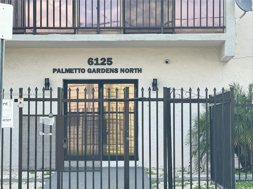 6125 W 20th Ave Unit 306, Hialeah, FL 33012 - exterior space with a gate and stucco siding