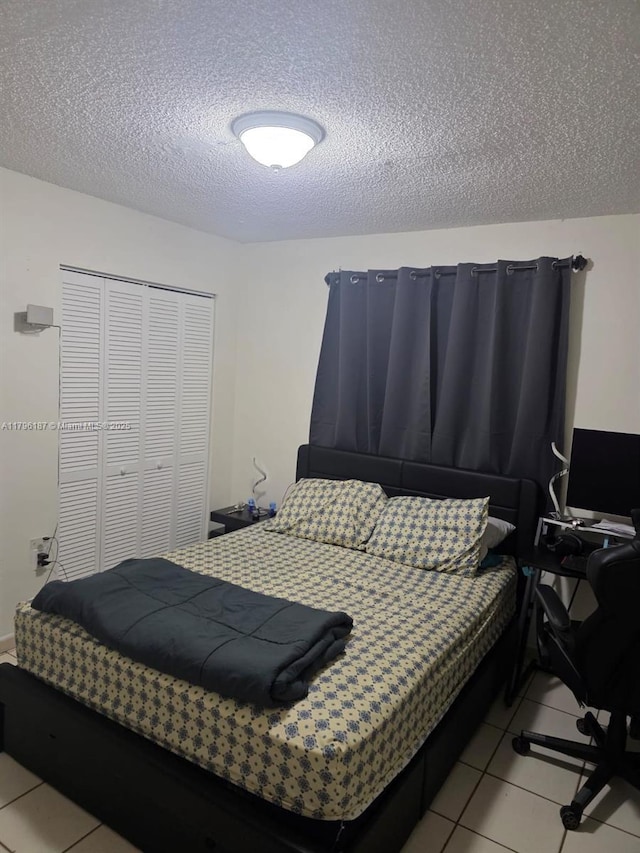 6215 W 22nd Ct Unit 15, Hialeah, FL 33016 - tiled bedroom with a textured ceiling and a closet