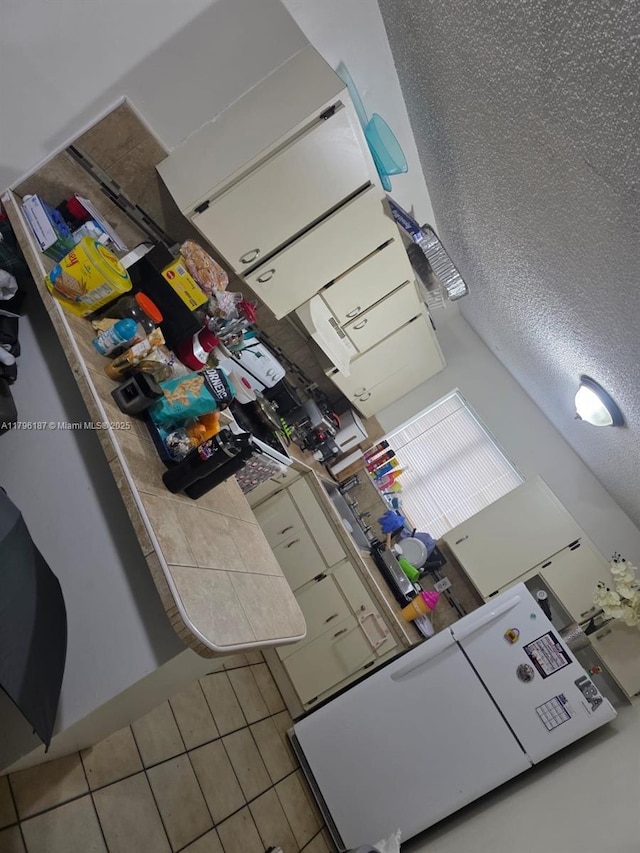 6215 W 22nd Ct Unit 15, Hialeah, FL 33016 - kitchen featuring tile patterned floors and tile countertops