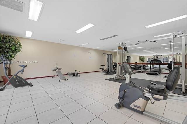 gym featuring baseboards and visible vents