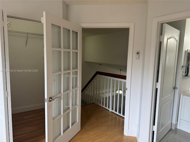 hall featuring baseboards and wood finished floors