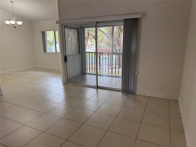 tiled empty room with baseboards, a notable chandelier, and lofted ceiling