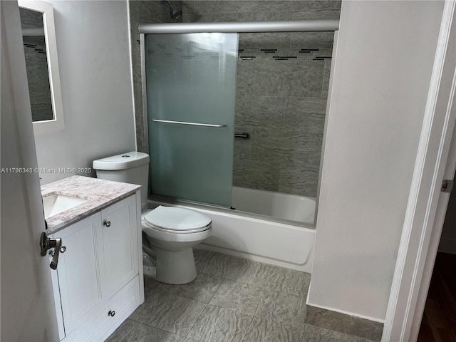 full bath featuring vanity, bath / shower combo with glass door, and toilet