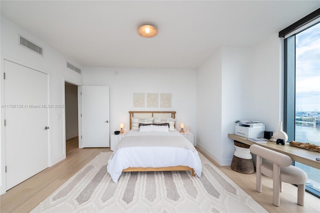 788 NE 23rd St Unit 2901, Miami, FL 33137 - bedroom with light wood finished floors and a wall of windows