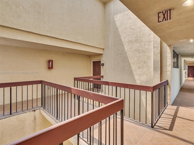 doorway to property featuring a balcony and stucco siding