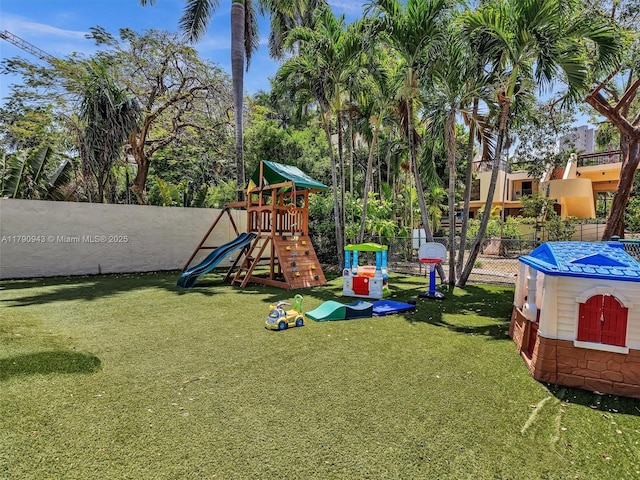 view of playground with a yard and fence