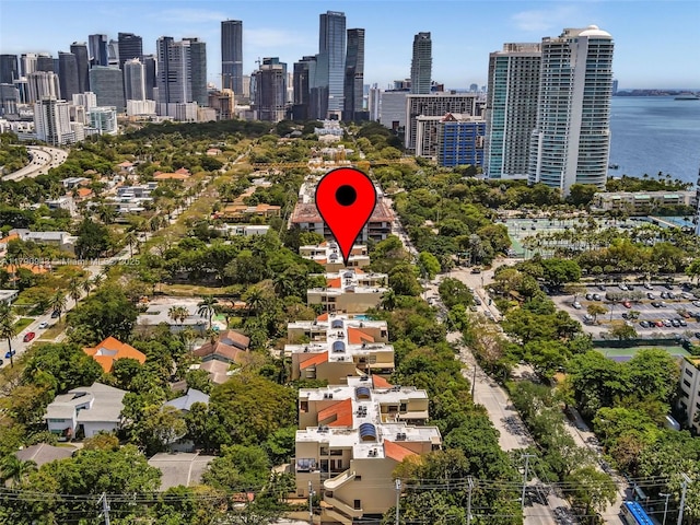drone / aerial view featuring a view of city and a water view
