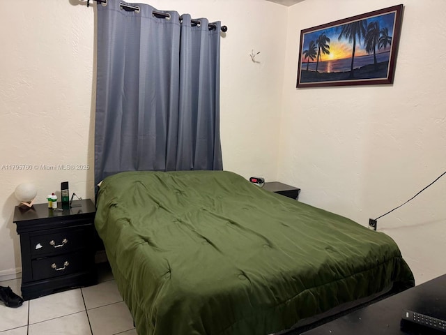 bedroom featuring light tile patterned flooring