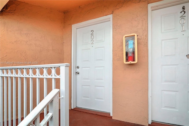 doorway to property with stucco siding