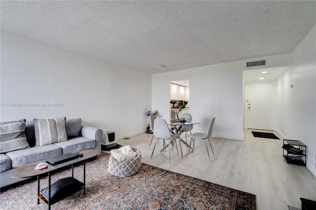 2350 NE 135th St Unit 510, North Miami, FL 33181 - living area with light wood-style floors and a textured ceiling