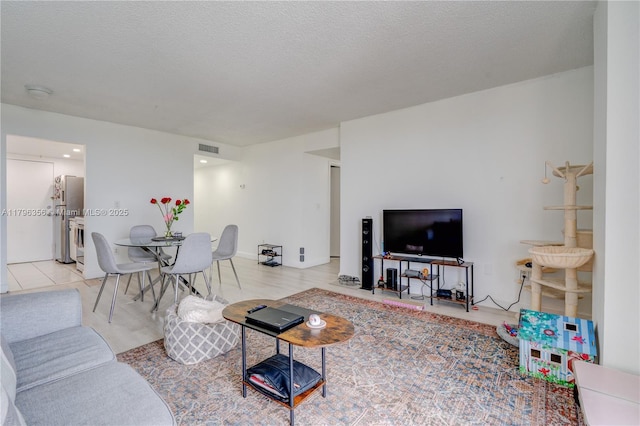 2350 NE 135th St Unit 510, North Miami, FL 33181 - living room featuring a textured ceiling