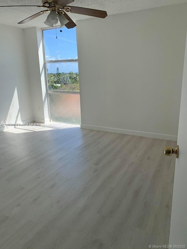 2350 NE 135th St Unit 510, North Miami, FL 33181 - empty room with a textured ceiling, ceiling fan, and wood finished floors