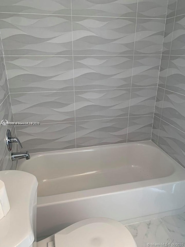 2350 NE 135th St Unit 510, North Miami, FL 33181 - bathroom featuring shower / bath combination and marble finish floor