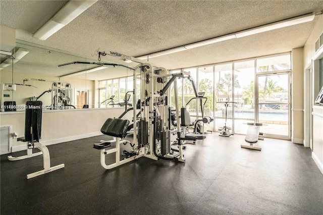 2350 NE 135th St Unit 510, North Miami, FL 33181 - workout area with baseboards, expansive windows, a textured ceiling, and a wealth of natural light