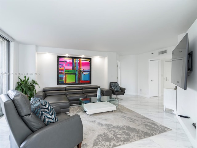 living area with baseboards, marble finish floor, and visible vents