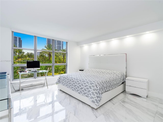 bedroom featuring baseboards and marble finish floor