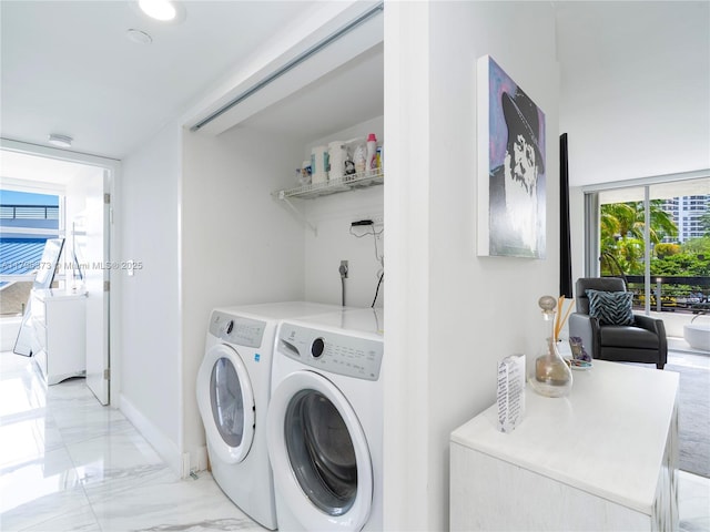 washroom with marble finish floor, laundry area, and washer and clothes dryer