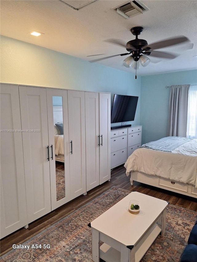 423 SW 80th Ave, North Lauderdale, FL 33068 - bedroom with dark wood-type flooring, a textured ceiling, and a ceiling fan