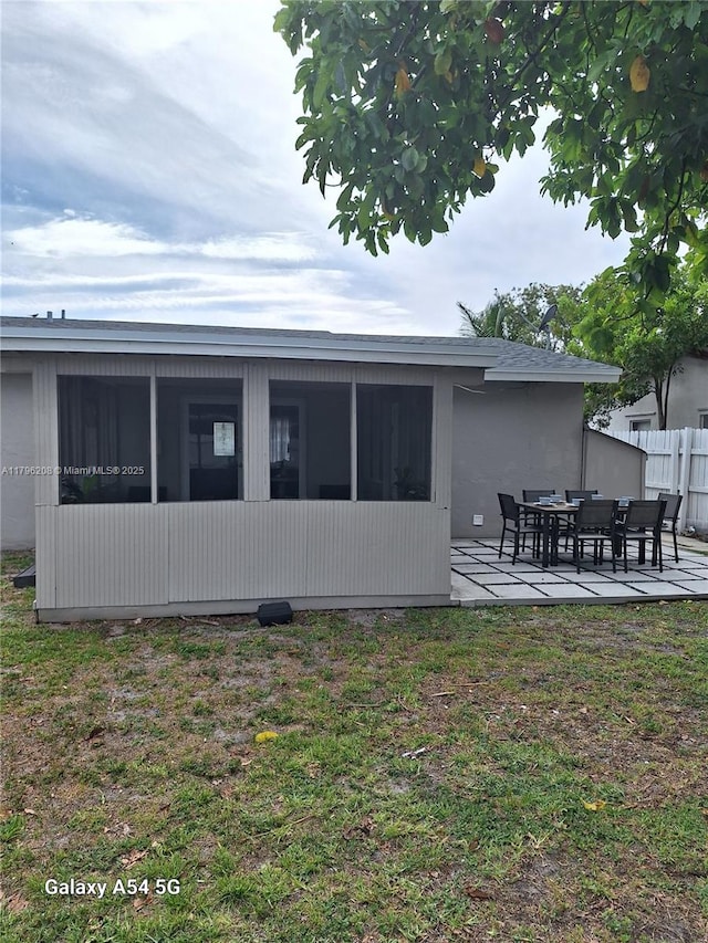 423 SW 80th Ave, North Lauderdale, FL 33068 - rear view of property featuring fence, a patio area, and a sunroom