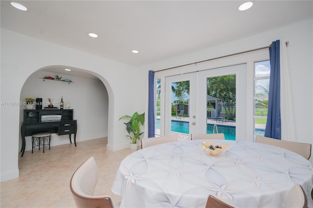 717 E River Dr, Margate, FL 33063 - dining space with recessed lighting, french doors, arched walkways, light tile patterned floors, and baseboards