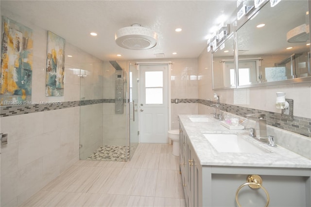 717 E River Dr, Margate, FL 33063 - bathroom featuring a stall shower, double vanity, tile walls, tile patterned floors, and recessed lighting