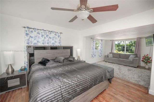 717 E River Dr, Margate, FL 33063 - bedroom featuring wood finished floors, multiple windows, a ceiling fan, and baseboards