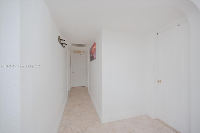 717 E River Dr, Margate, FL 33063 - hall with light tile patterned floors, baseboards, and arched walkways