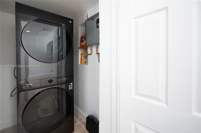 717 E River Dr, Margate, FL 33063 - laundry area featuring stacked washer and clothes dryer, baseboards, and tile patterned flooring
