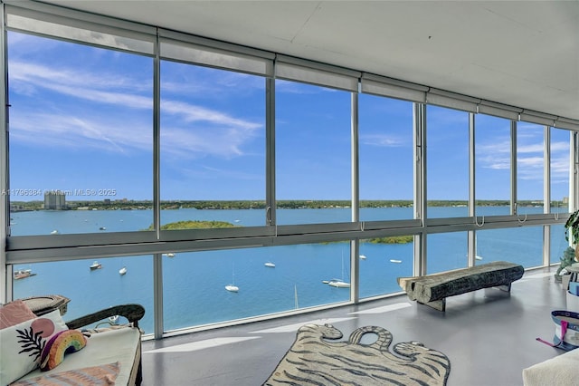 sunroom / solarium featuring a water view