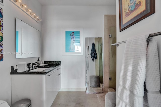 full bath featuring toilet, a shower stall, and vanity