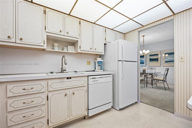 1980 S Ocean Dr Unit Mk, Hallandale Beach, FL 33009 - kitchen featuring an inviting chandelier, white appliances, light colored carpet, light countertops, and a sink