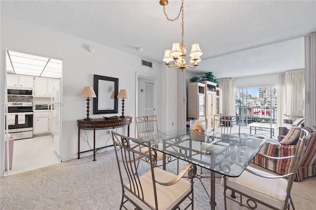 1980 S Ocean Dr Unit Mk, Hallandale Beach, FL 33009 - dining space featuring visible vents, a textured ceiling, a notable chandelier, and light colored carpet