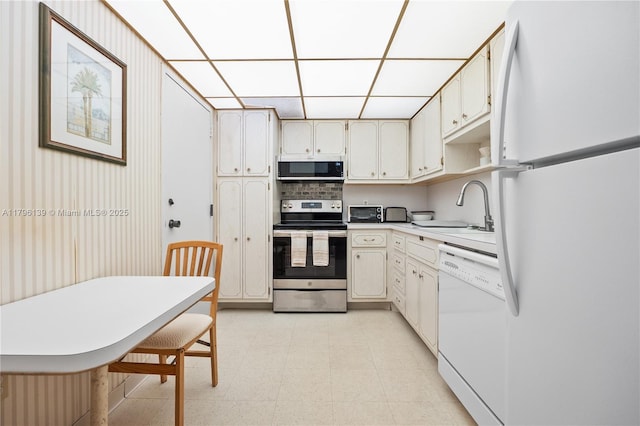 1980 S Ocean Dr Unit Mk, Hallandale Beach, FL 33009 - kitchen featuring white appliances, light floors, light countertops, a paneled ceiling, and a sink