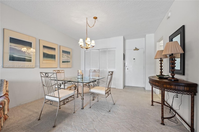 1980 S Ocean Dr Unit Mk, Hallandale Beach, FL 33009 - dining room with light colored carpet, a textured ceiling, and a notable chandelier